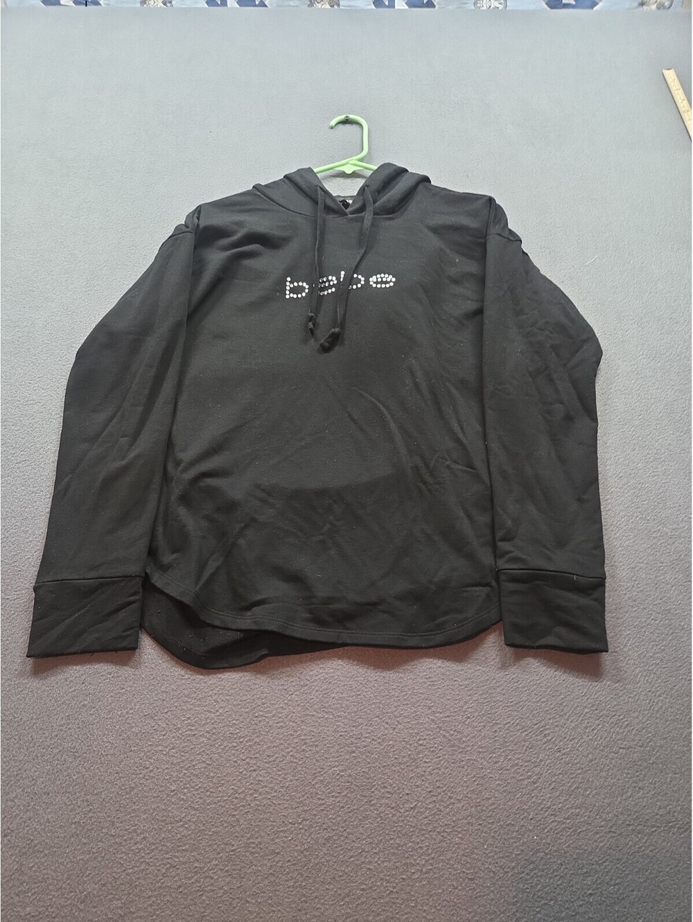 women's black long-sleeve hooded sweatshirt by Bebe size M